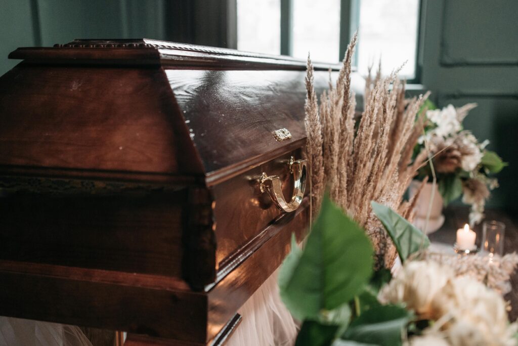 A casket surrounded by flowers.